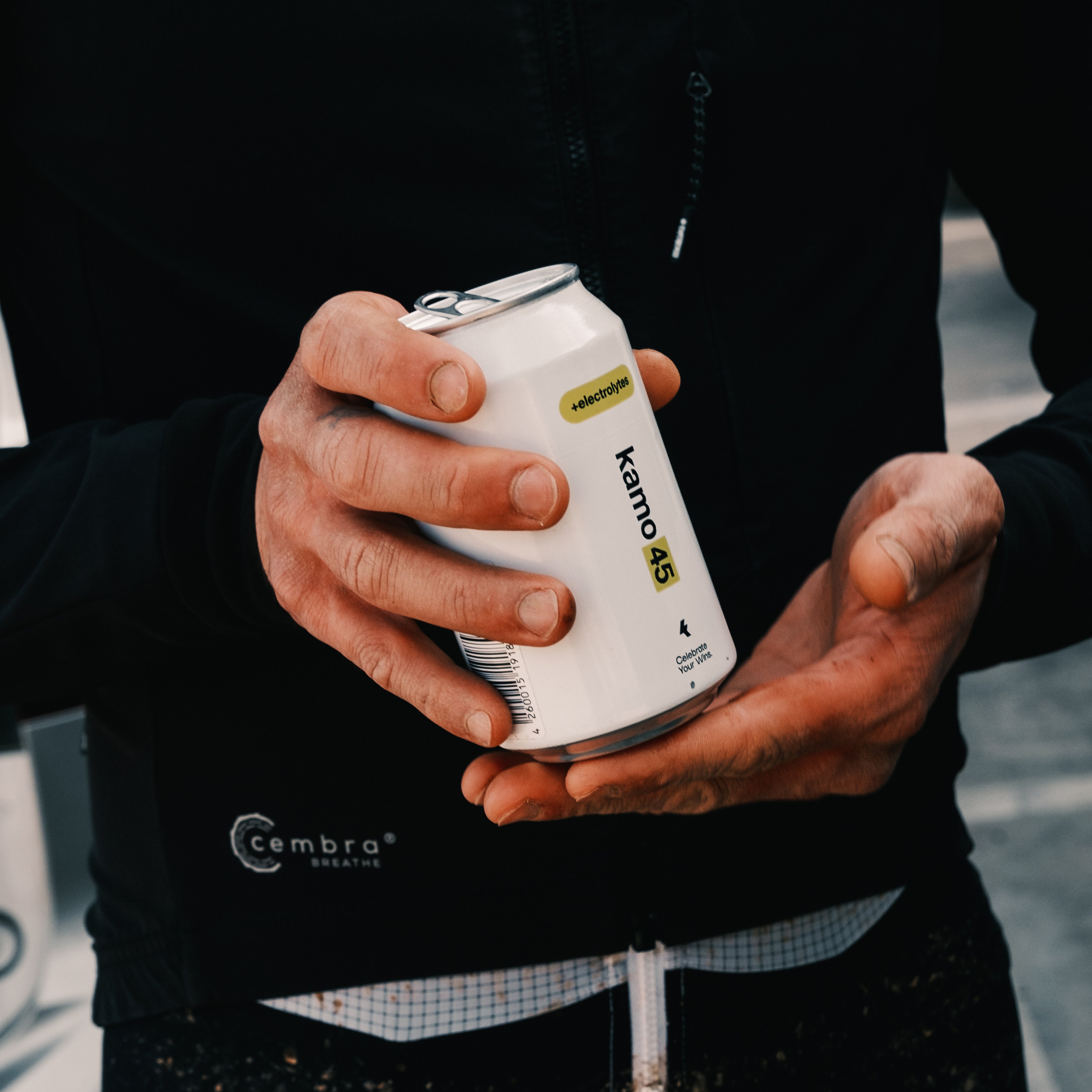 Person holding a white can with 'kamo 45' branding 